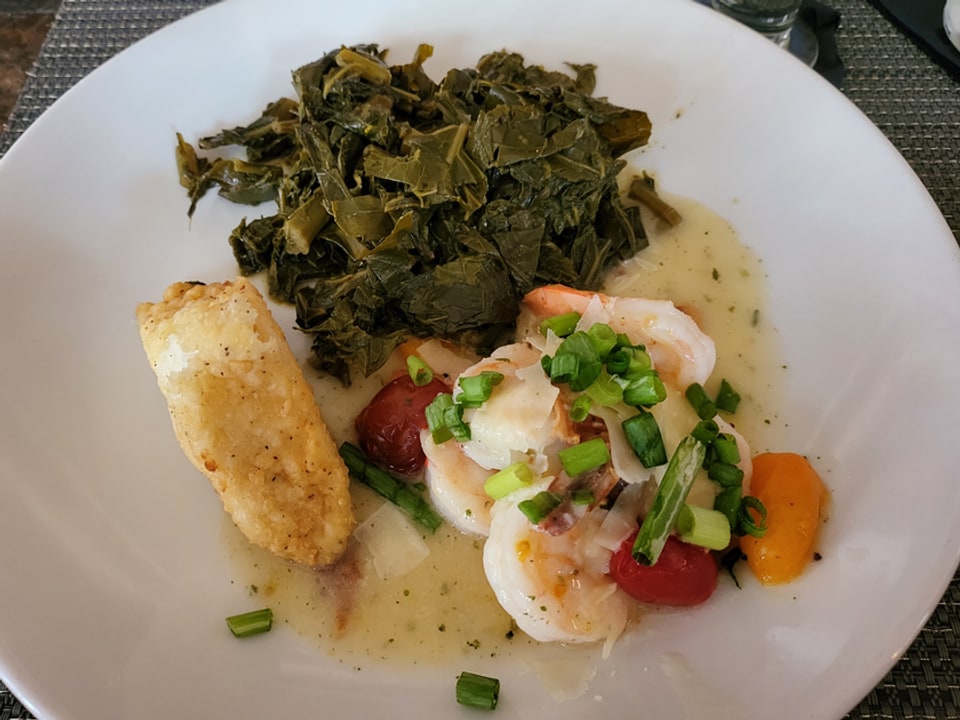 Shrimp, collard greens, and a grit cake at Belford's Savannah.