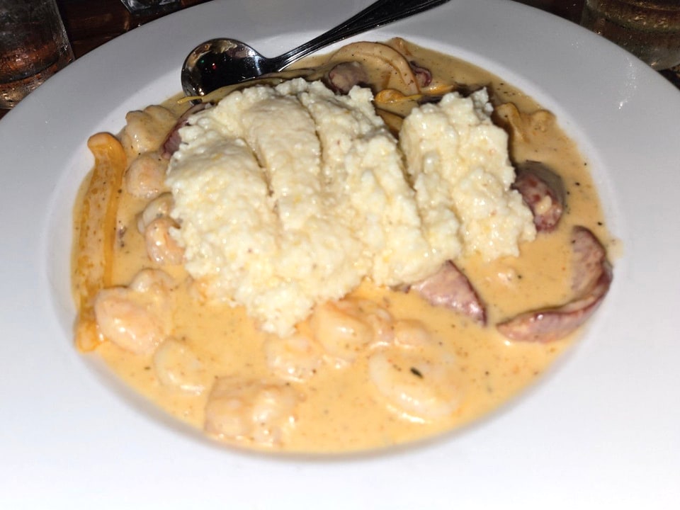 Cheddar grits surrounded by shrimp, sausage, and gravy at Boar's Head.