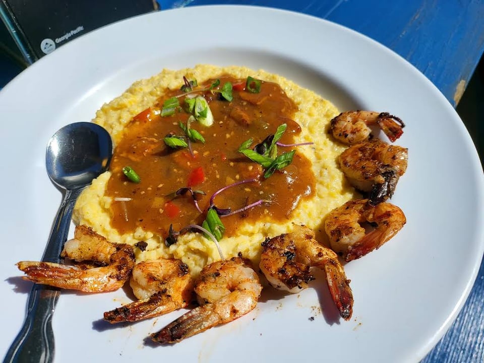 Shrimp arranged around grits with brown sauce at Bubba Gumbo's.