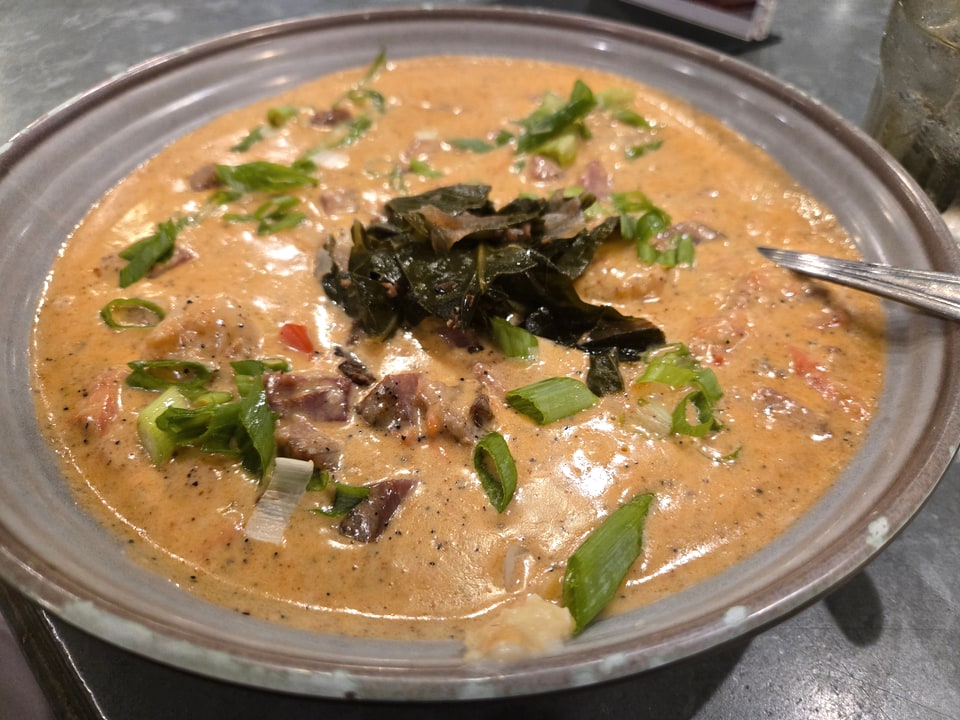 Shrimp and grits submerged in tasso gravy at The 5 Spot Sandfly.