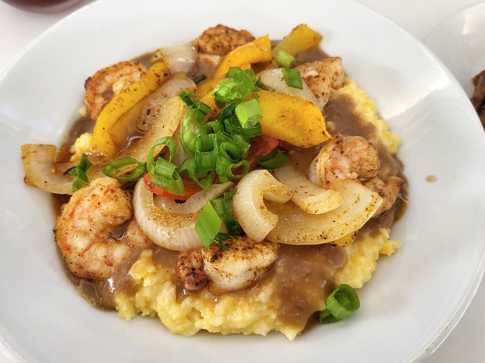 Shrimp and grits with peppers and onions at Fork & Dagger.