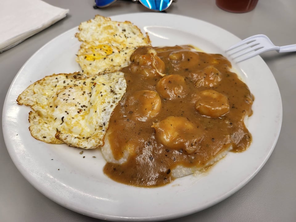 Smothered shrimp and grits in brown gravy with two eggs at NaRobia's.
