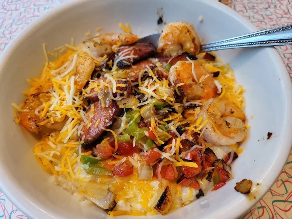 Shrimp and grits with cheese, peppers, onions, and tomatoes at The Palace Diner.