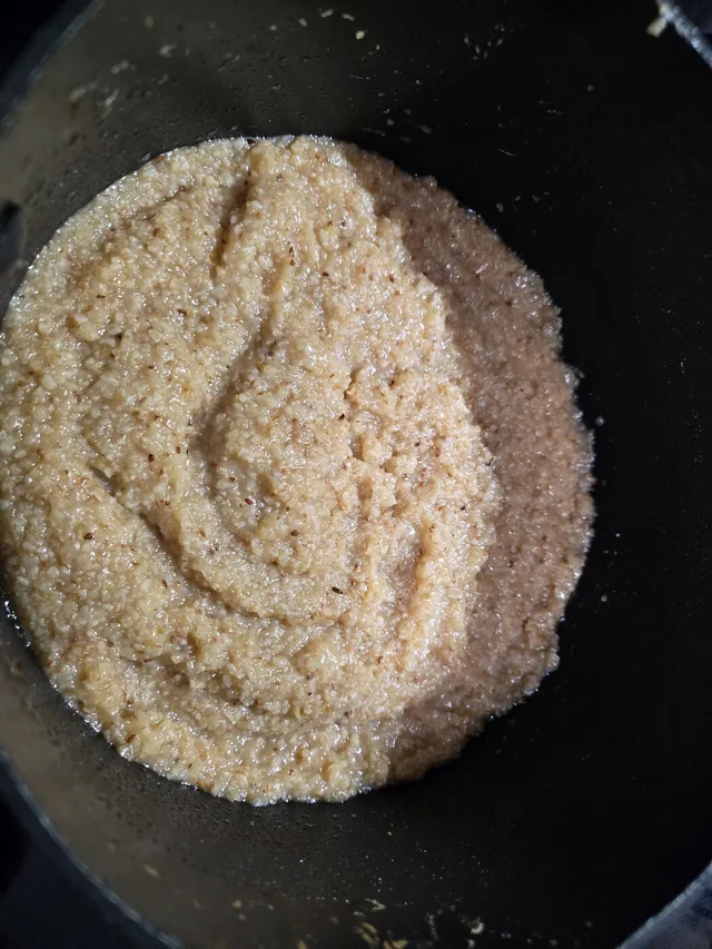 Cooked grits in the pot, thick and creamy