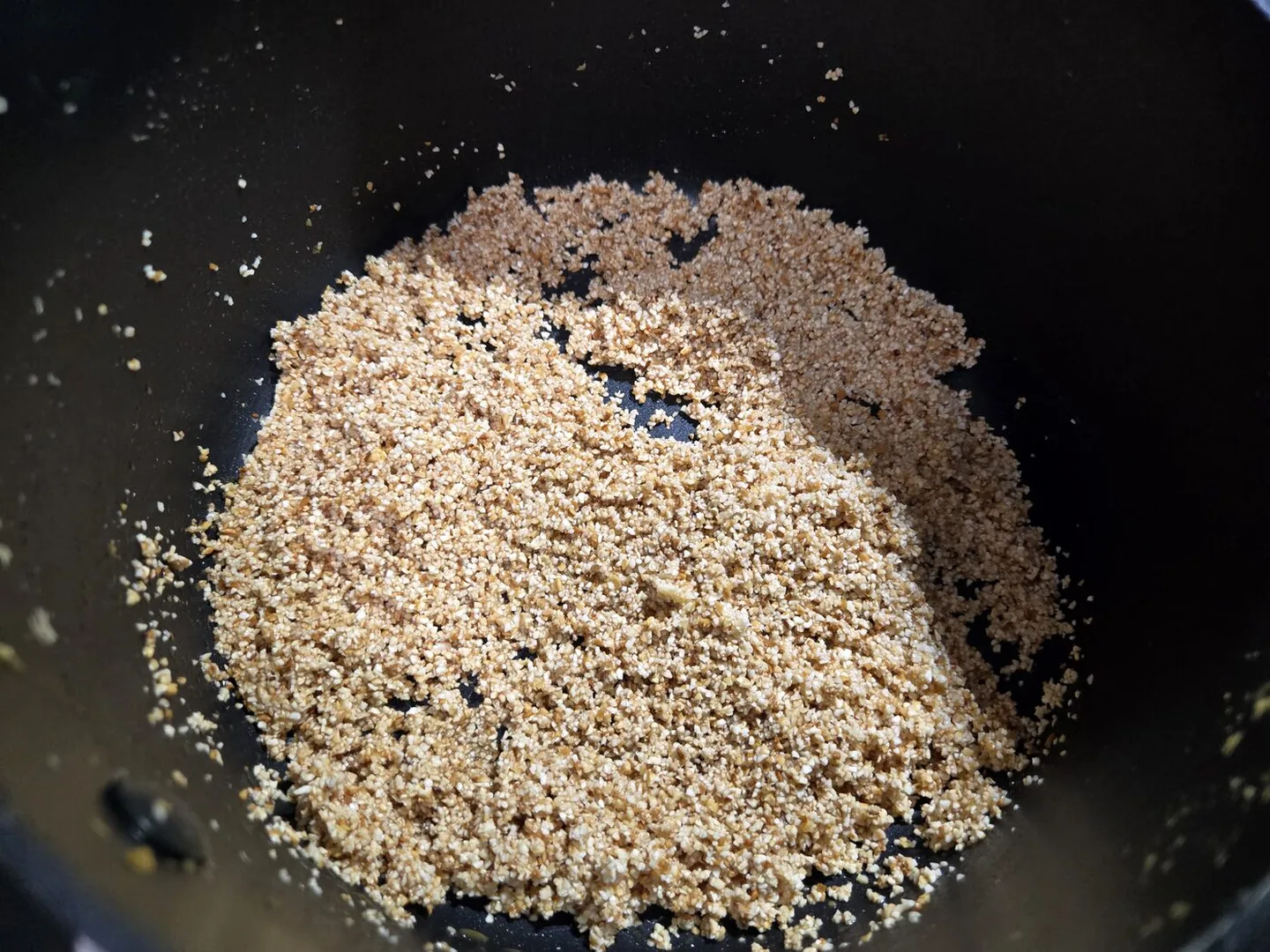 Grits toasting in the pan, turning golden