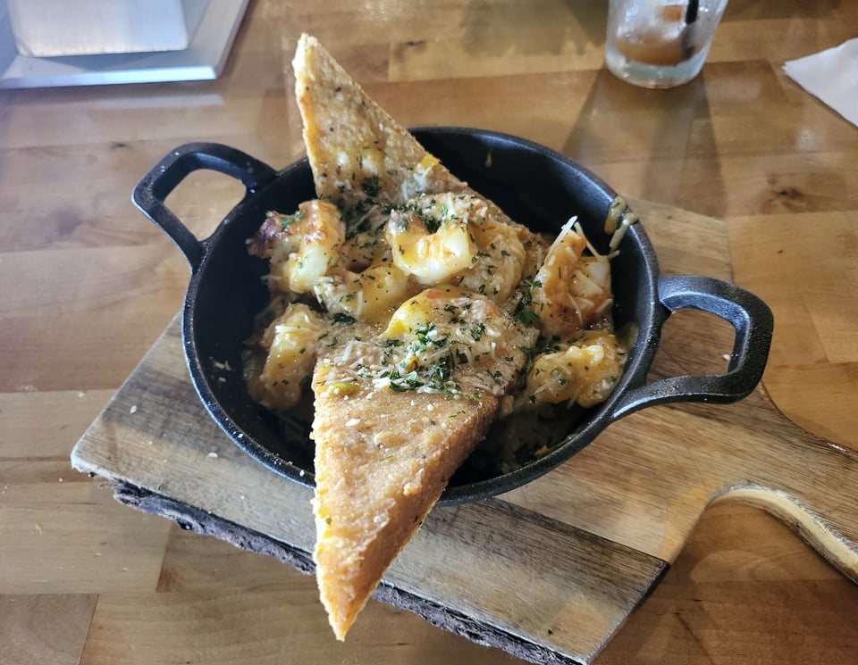 Shrimp with fried grit cakes in a small skillet at The Nest.