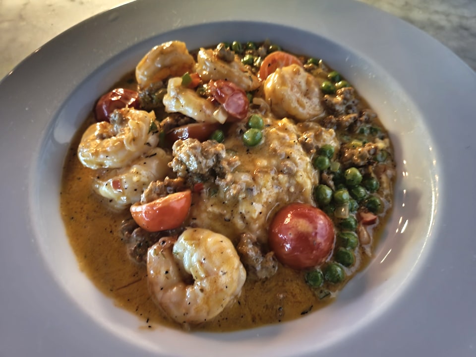 Shrimp and grits with tomatoes and peas at The Public.