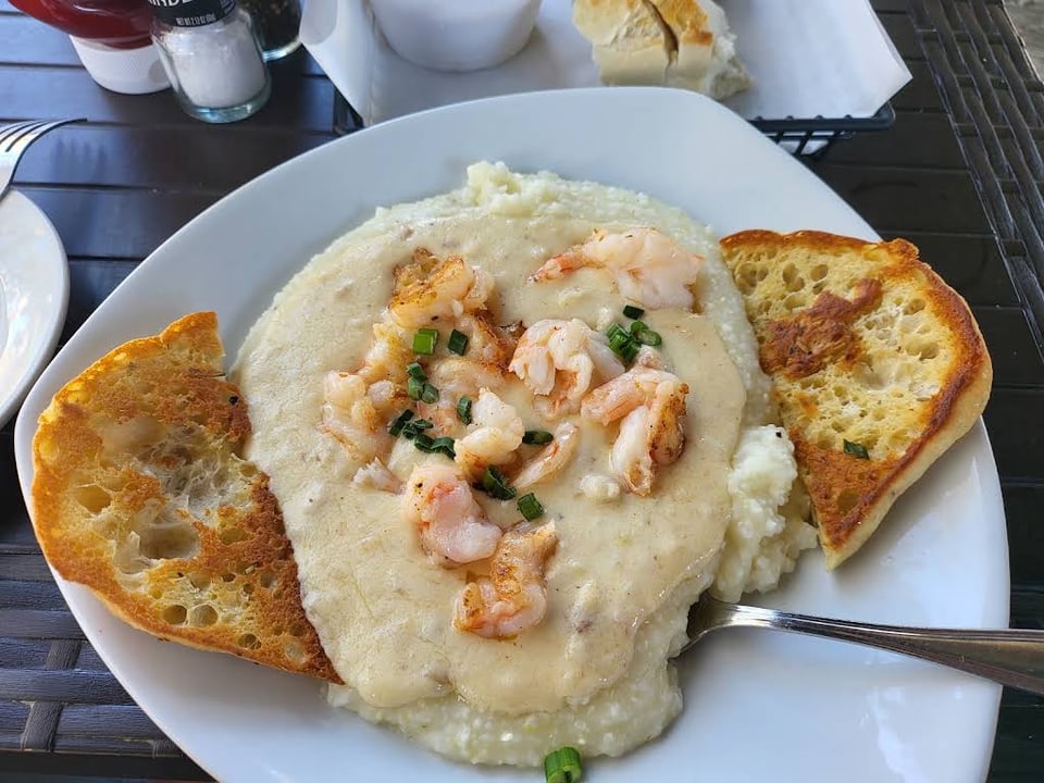 Shrimp and grits with pale sauce and toast at Tubby's Tank House.